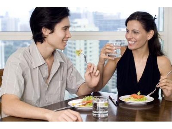 Young couple eating salads together