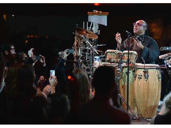 Stevie Wonder playing a variety of instruments in concert.