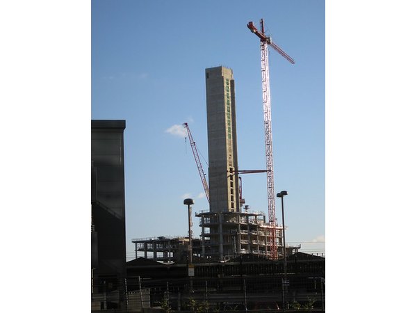 Cranes are used in the construction of tall buildings.