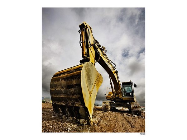 An excavator prepares to dig up at a construction site.