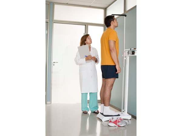 A man's height is measured in a medical center.