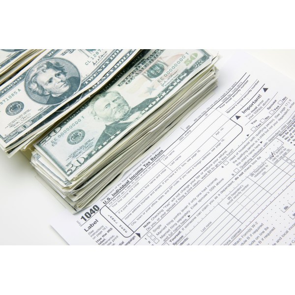 Creatas/Creatas/Getty Images Tax forms with money
