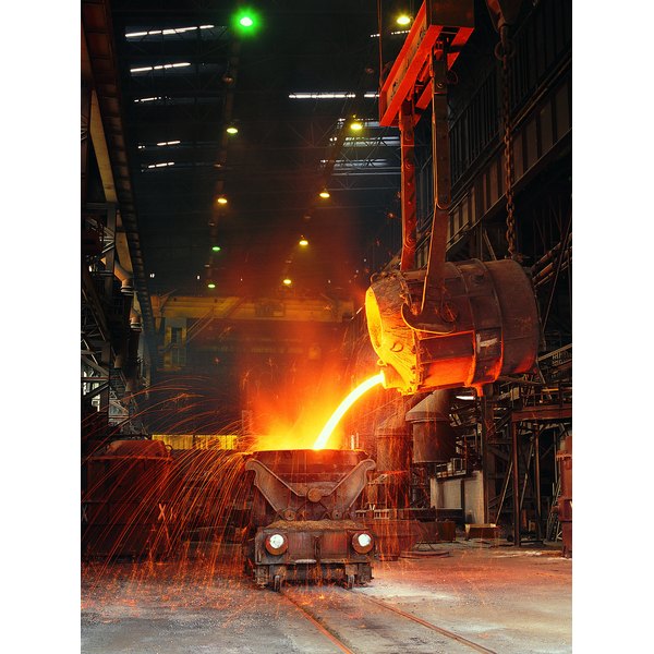 Digital Vision./Digital Vision/Getty Images Pouring molten steel into tank