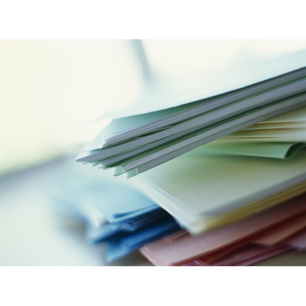 Ciaran Griffin/Stockbyte/Getty Images stack of files