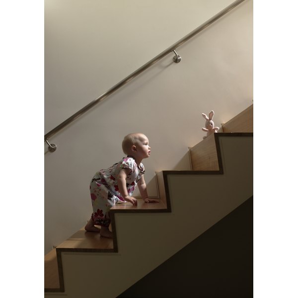 Ryan McVay/Lifesize/Getty Images Baby girl climbing stairs to get toy