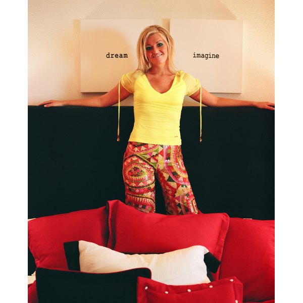NA/Photos.com/Getty Images Woman posing in room with retro decor