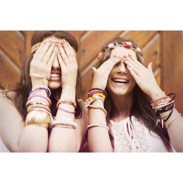 gpointstudio/iStock/Getty Images Boho girls covering eyes by hands