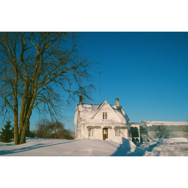 Photos.com/Photos.com/Getty Images Snow-covered house and yard