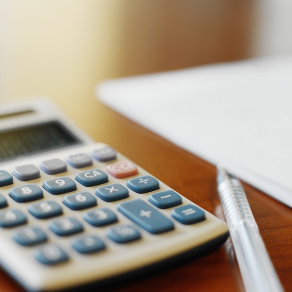 Ciaran Griffin/Stockbyte/Getty Images close-up of a calculator and a pen
