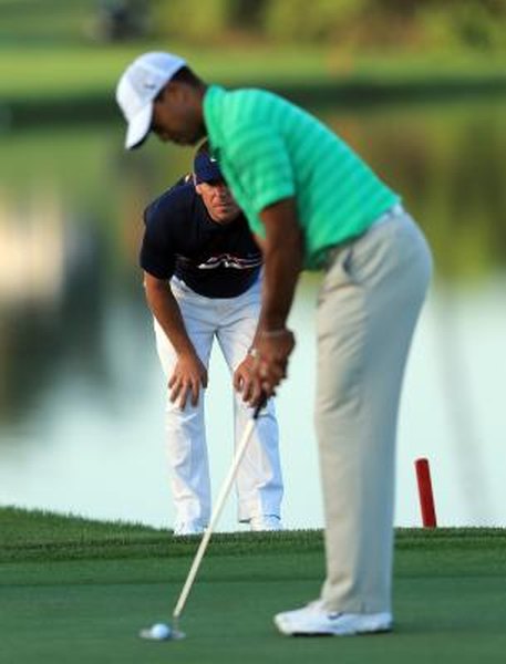 David Cannon/Getty Images Sport/Getty Images Even the pros get help. Before he won the 2012 Arnold Palmer Invitational, Tiger Woods practiced under the watchful eye of his swing coach, Sean Foley.