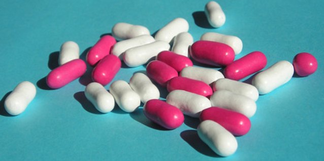 pink and white pills on bue image by Roslen Mack from Fotolia.com Too much of the wrong medication can actually worsen migraines.