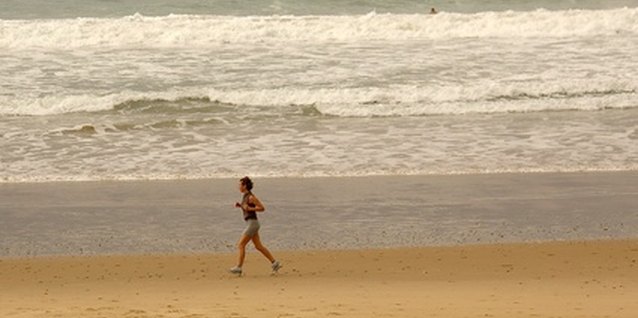 daily exercise. image by mdb from Fotolia.com Running on the beach makes exercise more appealing.