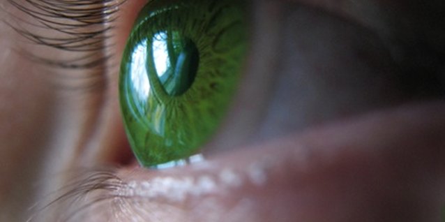 green lens 2 image by Bosko Martinovic from Fotolia.com Colored contact lenses enhance or change eye color.