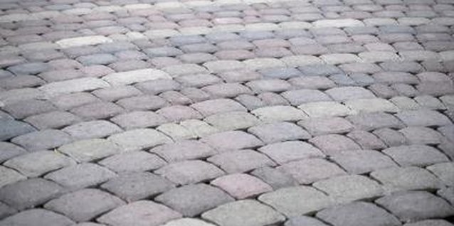 Hemera Technologies/AbleStock.com/Getty Images Keep extra paver bricks on hand in case one needs replacement.