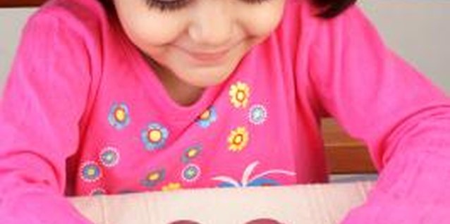 Visage/Stockbyte/Getty Images Counting bills and coins is a stepping stone for kids to learn how to use money.