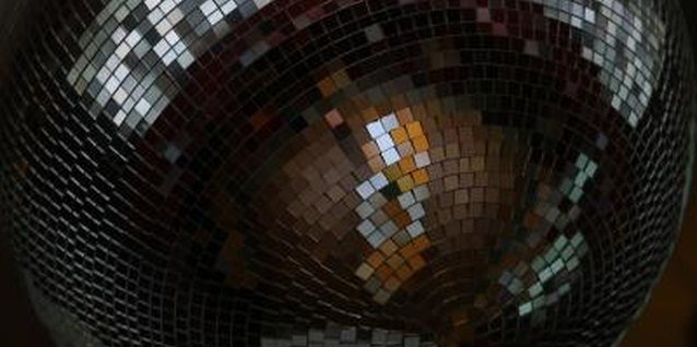 Jupiterimages/Photos.com/Getty Images Get her a costume that'll reflect a gazillion lights from the disco ball.