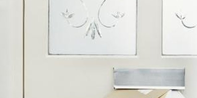 Digital Vision./Photodisc/Getty Images A simple frosted design adds privacy, lets in light and updates your entrance decor.