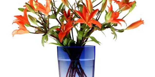 Brand X Pictures/Brand X Pictures/Getty Images A floral centerpiece of fresh lilies adds a summer touch to your table.