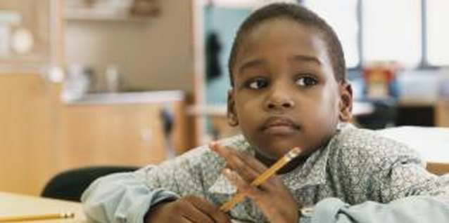 Digital Vision./Digital Vision/Getty Images A child who daydreams through his work might have an attention deficit.