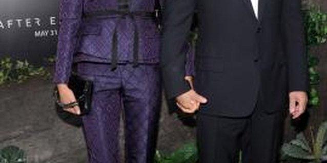 Jamie McCarthy/Getty Images Entertainment/Getty Images Emma Hemming with husband Bruce Willis wearing a suit jacket with tapered pants.