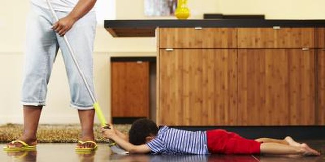 Thomas Northcut/Lifesize/Getty Images Make cleaning a bonding activity with your little one.