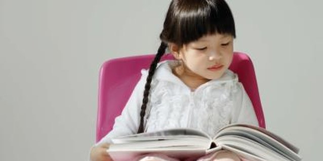 Jupiterimages/Goodshoot/Getty Images Gifted kids often prefer reading to playing with their friends.