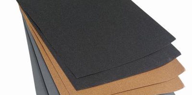 Stockbyte/Stockbyte/Getty Images Aluminum oxide sandpaper is the most effective for wooden furniture.