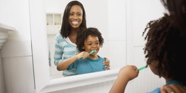 Jupiterimages/Brand X Pictures/Getty Images Embellishments around a perimeter of a bathroom mirror give it more style.