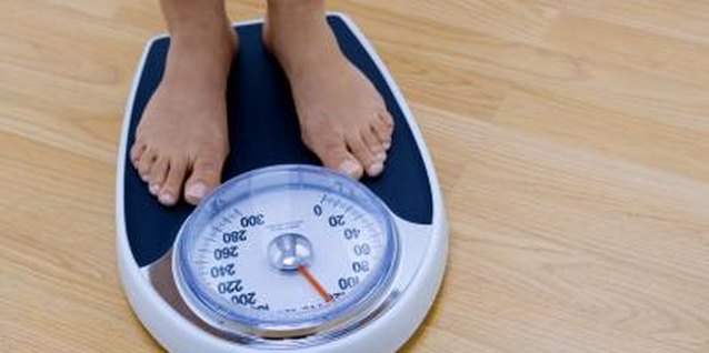 Creatas Images/Creatas/Getty Images Avoid weighing yourself every day to keep from obsessing over the numbers.