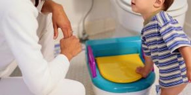 Ryan McVay/Photodisc/Getty Images Some toddlers avoid having a bowel movement if it will cause pain.