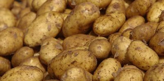 Hemera Technologies/AbleStock.com/Getty Images A potato tower reduces the amount of ground space required to grow the vegetables.