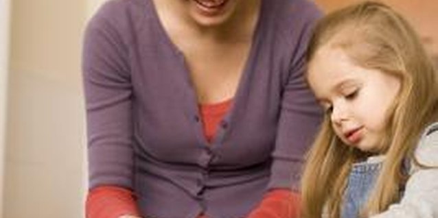 Thinkstock Images/Comstock/Getty Images Learning basic kitchen skills is an objective for kids.