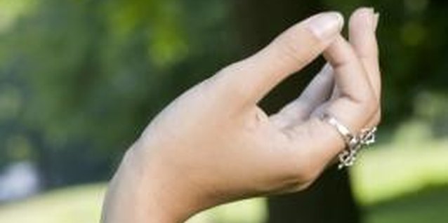 Creatas Images/Creatas/Getty Images Use finger and hand exercises to help strengthen the non-dominant hand.
