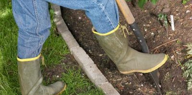 Hemera Technologies/Photos.com/Getty Images Dig a trench to set concrete in-ground for a clean mowing edge.