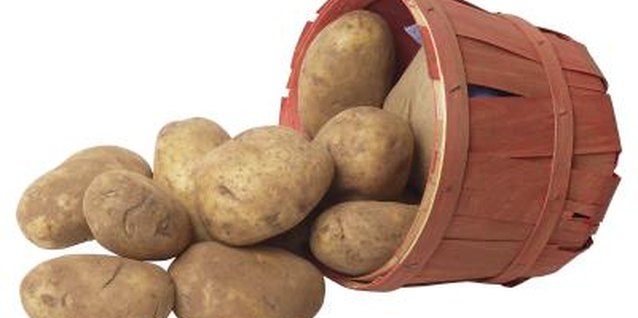 Hemera Technologies/PhotoObjects.net/Getty Images Potatoes grow above the plant roots but beneath the soil surface.