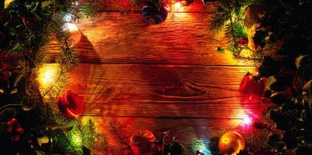 Stockbyte/Stockbyte/Getty Images Adding light to a holiday wreath creates a warm, inviting glow.