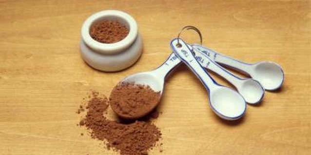 Jupiterimages/Stockbyte/Getty Images Measure cocoa powder with a measuring spoon for accuracy.