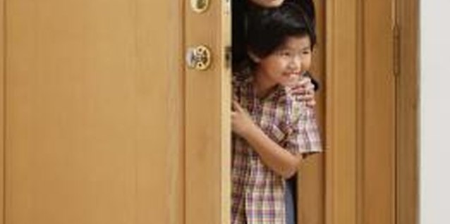 Jupiterimages/Goodshoot/Getty Images Practicing door manners as a family helps your child learn.