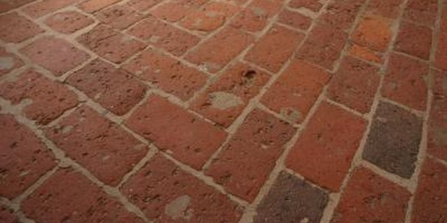 Jupiterimages/Photos.com/Getty Images Fire brick flooring creates a unique look for a bathroom.