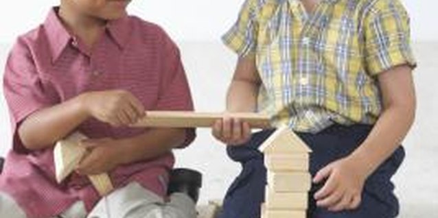 Brand X Pictures/Brand X Pictures/Getty Images Sharing toys is often very difficult for young kids.