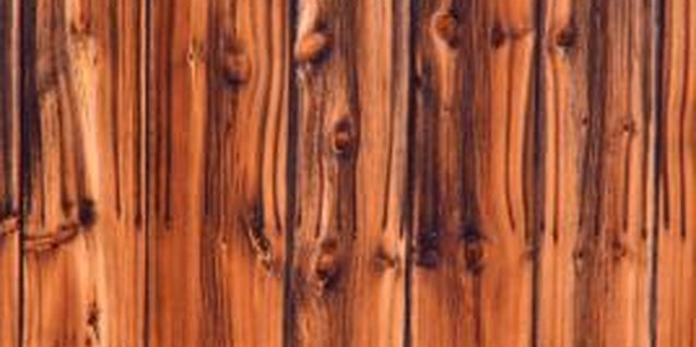 Jupiterimages/liquidlibrary/Getty Images Paneling contains a stain or glossy finish that repels or shows through paint.
