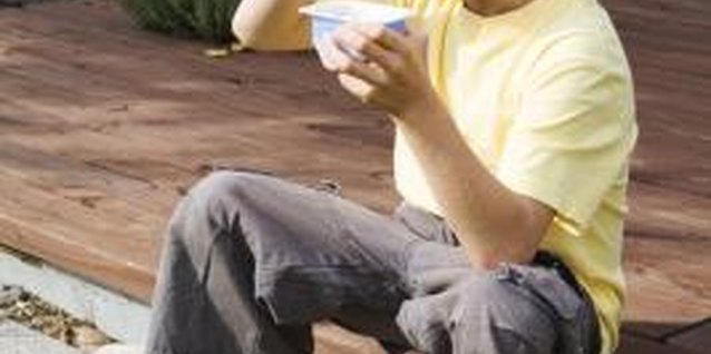 Jupiterimages/Creatas/Getty Images Probiotic yogurt can improve your child's digestive health.