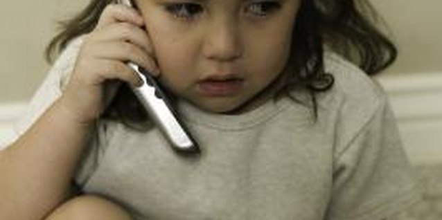 Photodisc/Photodisc/Getty Images Frequent phone calls to Daddy can help your child during a divorce.