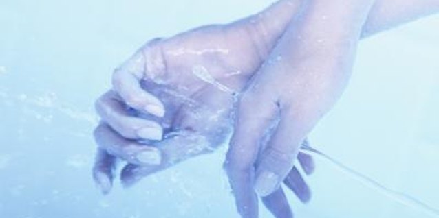 David De Lossy/Photodisc/Getty Images Frequent washing of the hands is a contributor to peeling around fingernails.