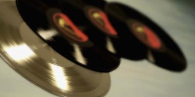 Medioimages/Photodisc/Photodisc/Getty Images Old vinyl records can give a plain room divider plenty of personality.