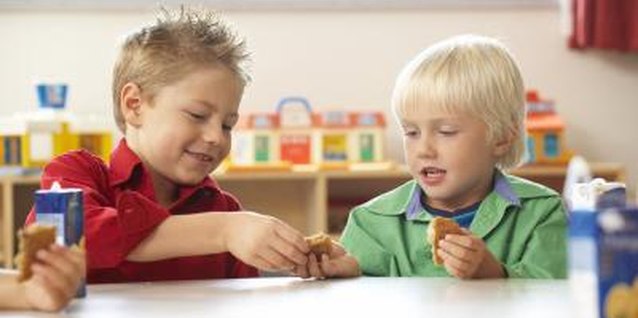 Jupiterimages/Photos.com/Getty Images Pointing out kind acts reinforces how you want your preschooler to act.