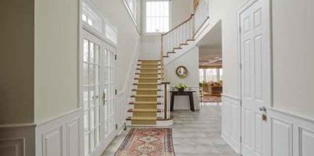 Jupiterimages/Creatas/Getty Images White walls, light-colored floors and natural light brighten a foyer.