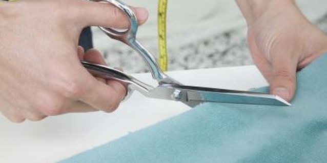 Jupiterimages/Brand X Pictures/Getty Images Secure teal fabric to an old gray curtain to lengthen and update it.
