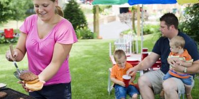 Creatas/Creatas/Getty Images Grill by example: kids chomp what their parents eat.