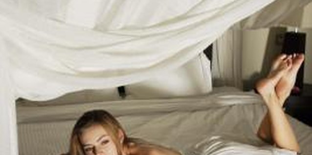 Jupiterimages/Goodshoot/Getty Images Sweet dreams await under a lighted canopy bed.